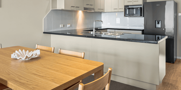 View of Dining table & kitchen in background