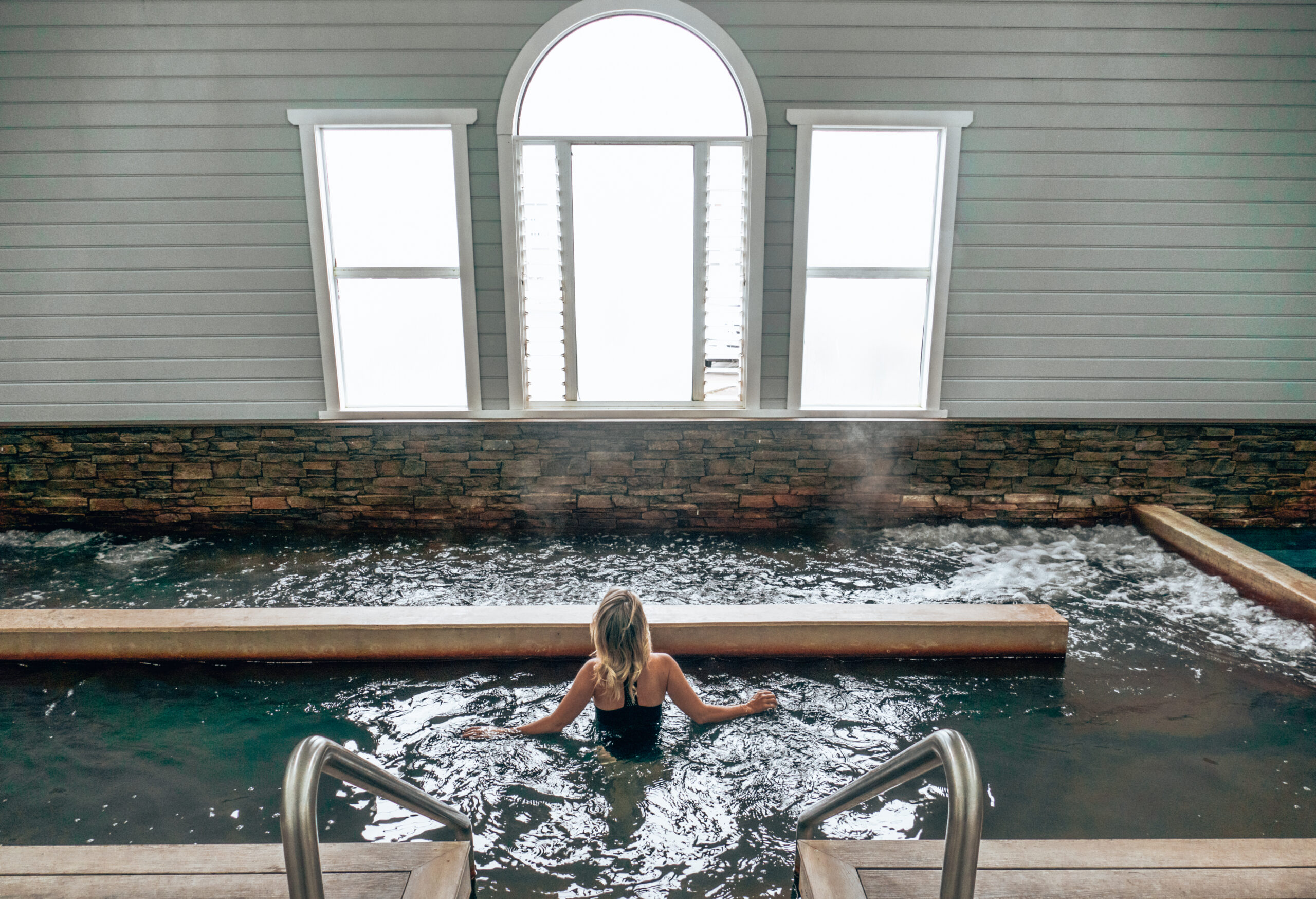 Woman soaking in geothermal waters at the indoor bath house
