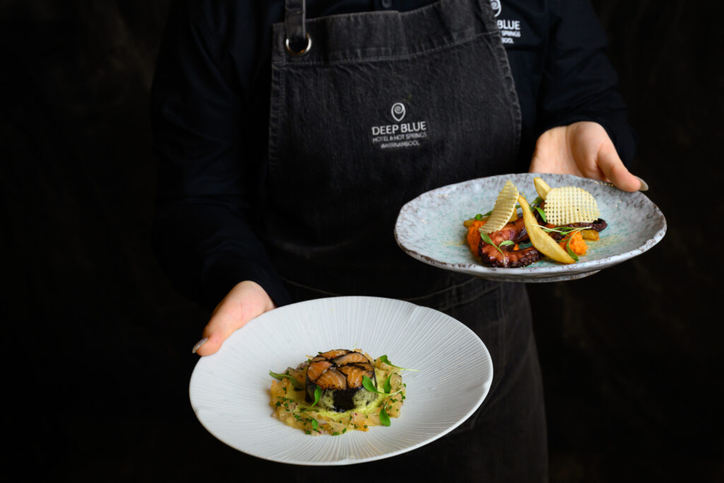 Waitress holding chef's tasting plates at Tides Cafe, Bar, and Restaurant Warrnambool